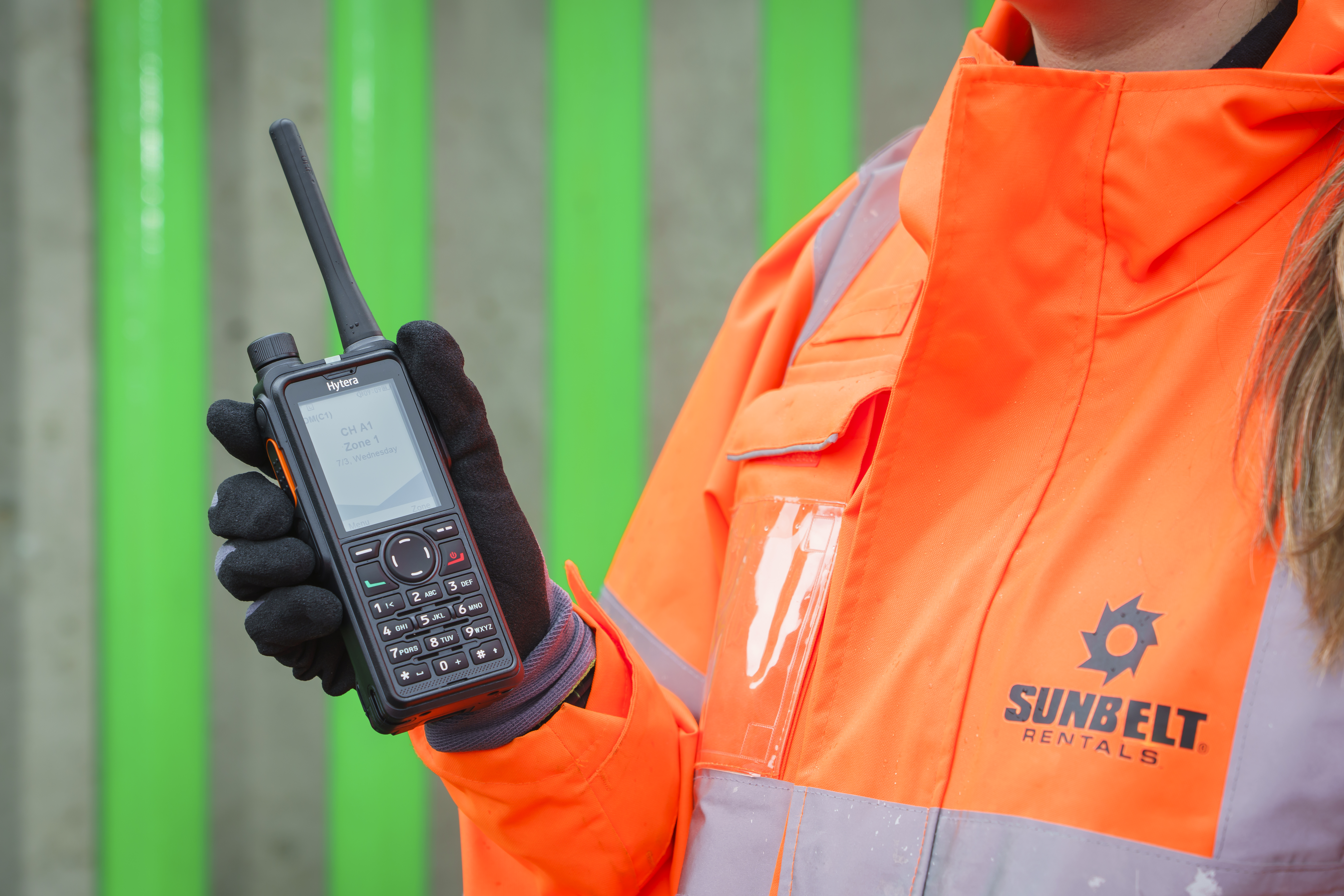 Person holding Hytera two-way radio.