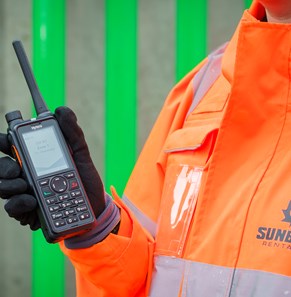Person holding Hytera two-way radio.