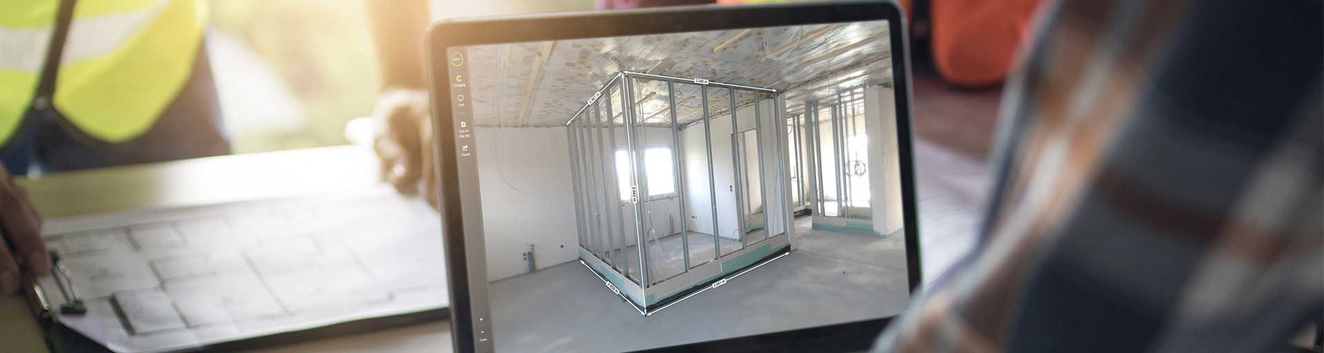 Project Manager On Site Using A Digital Project Solution At A Table